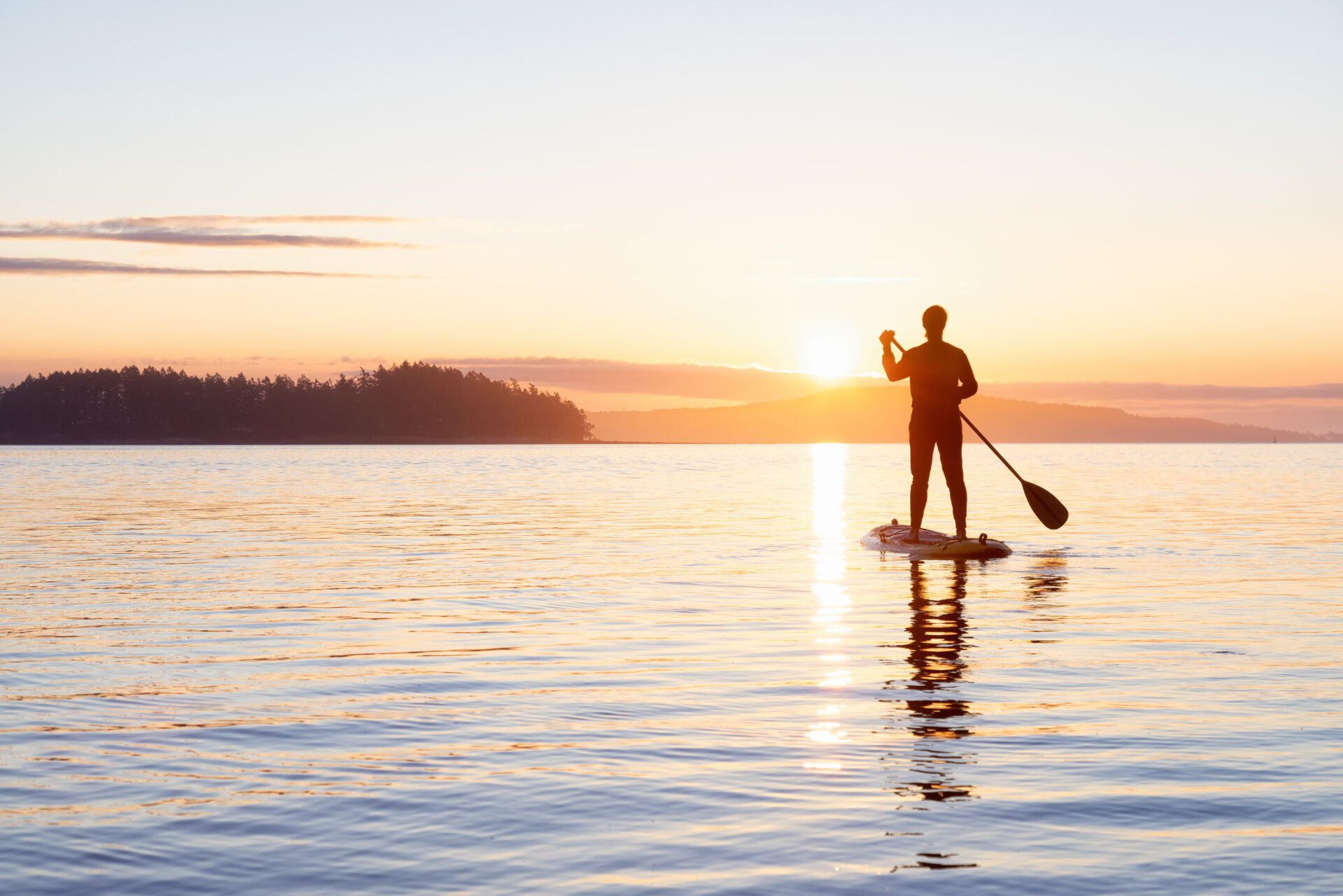 Adventurous Caucasian Adult Woman on a Stand Up Paddle Board